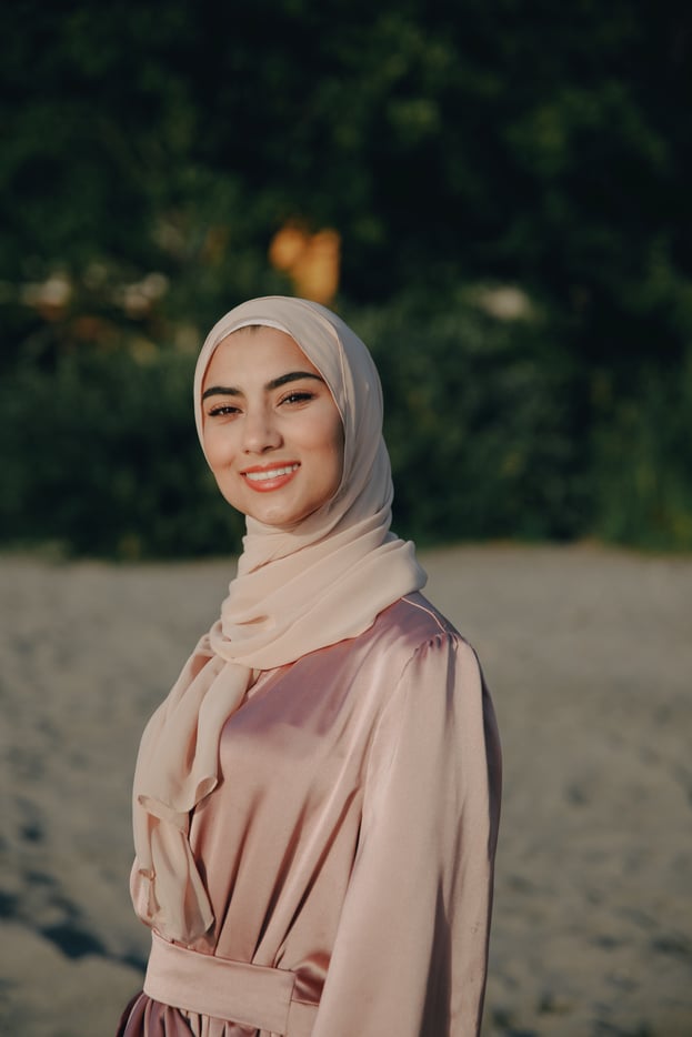 A Woman Wearing a Headscarf and Pink Silk Dress 